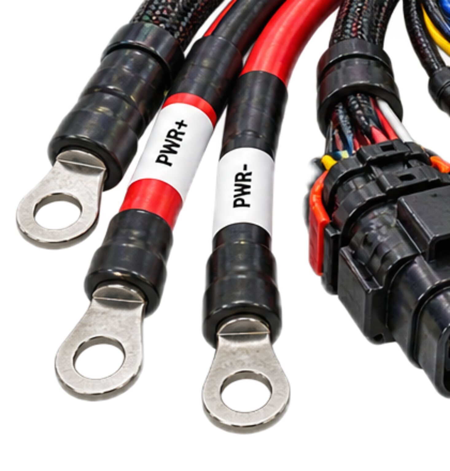 Two power leads on ring terminals, marked positive and negative, beside a sealed connector, from an illustration.
